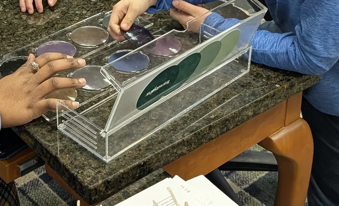 A tray of demonstration lenses on the granite counter at Evergreen Eye Care.
